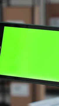 Vertical video. Man using tablet computer with green screen chromakey. Browsi Stock Photos