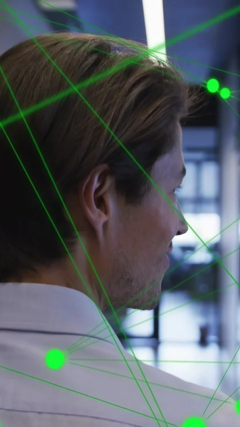 Vertical video: Man walking hall, turning right, initiating green node mapping Stock Footage 334025026