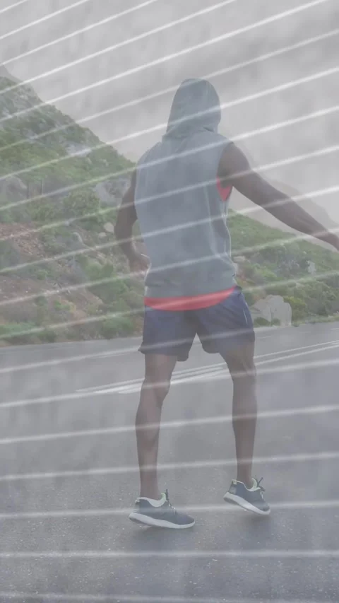 Vertical video: Man walking road, pivoting into running to fog while streaks Stock Footage 337538908
