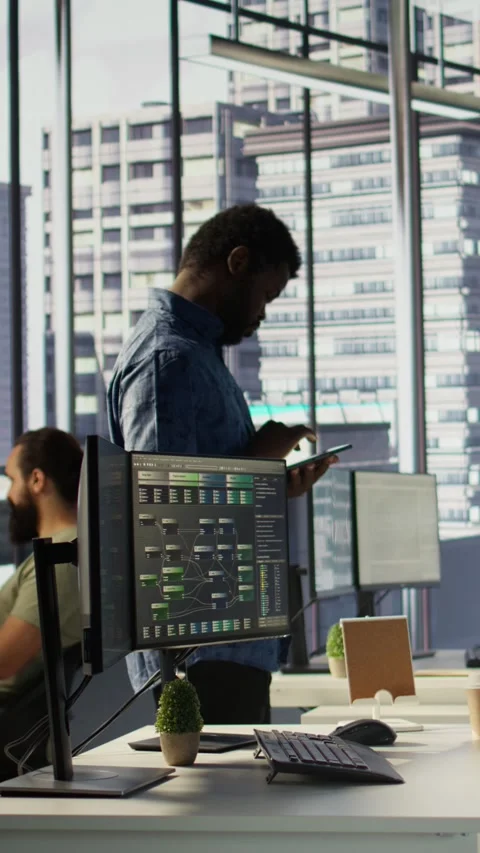 Vertical video Man walking with tablet in office, fixing coding issues Stock Footage 319491466