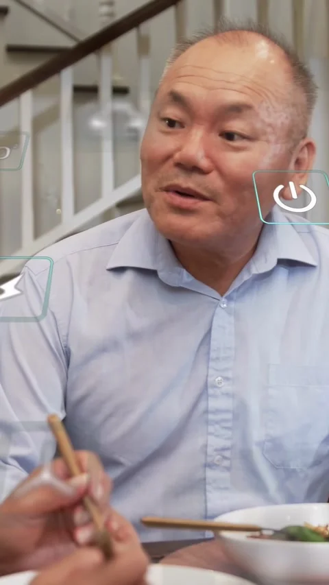 Vertical video: Man watching other lifting noodles, reacting as tech UI icons Stock Footage 333913014