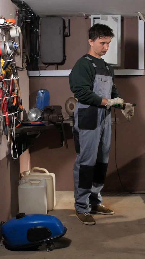 Vertical video man wearing protective overalls and gloves, preparing for work Stock Footage 342770711
