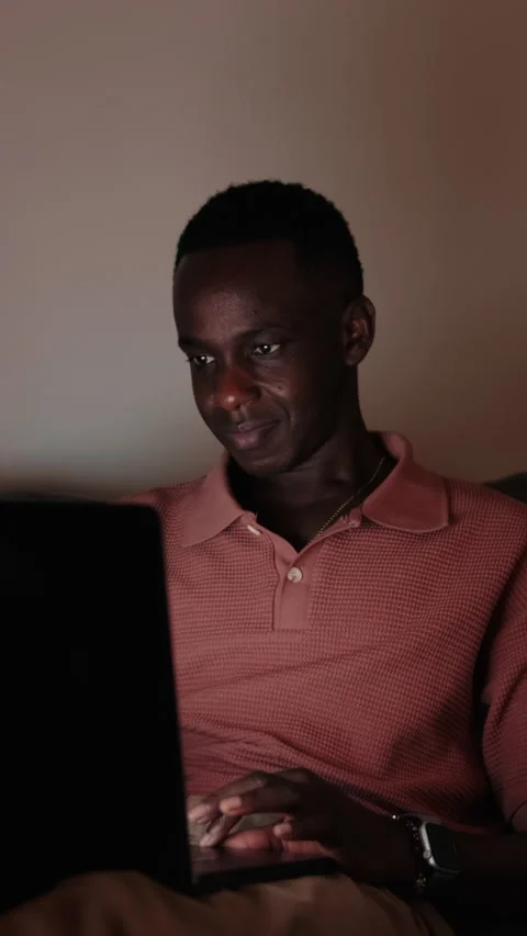 Vertical video, Man Working on Laptop at Night on Couch in the dark room Stock Footage 315396252