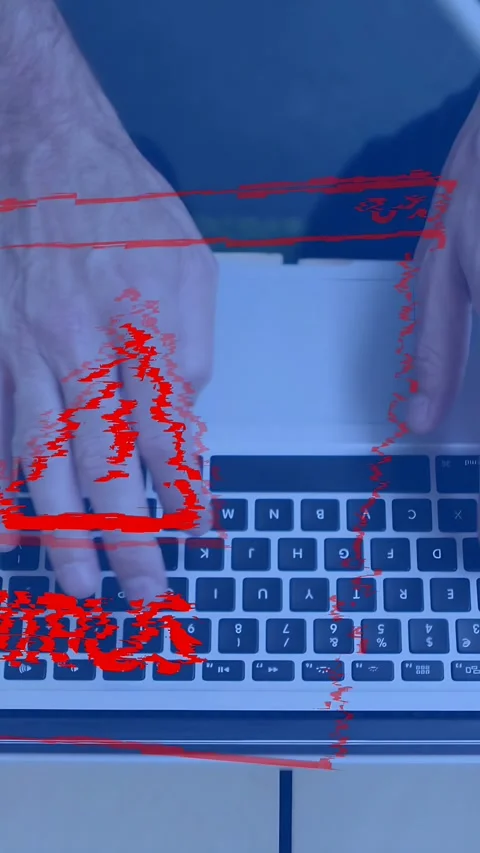 Vertical video: Man working on laptop in IT, causing red VIRUS alert glitching Stock Footage 334770957