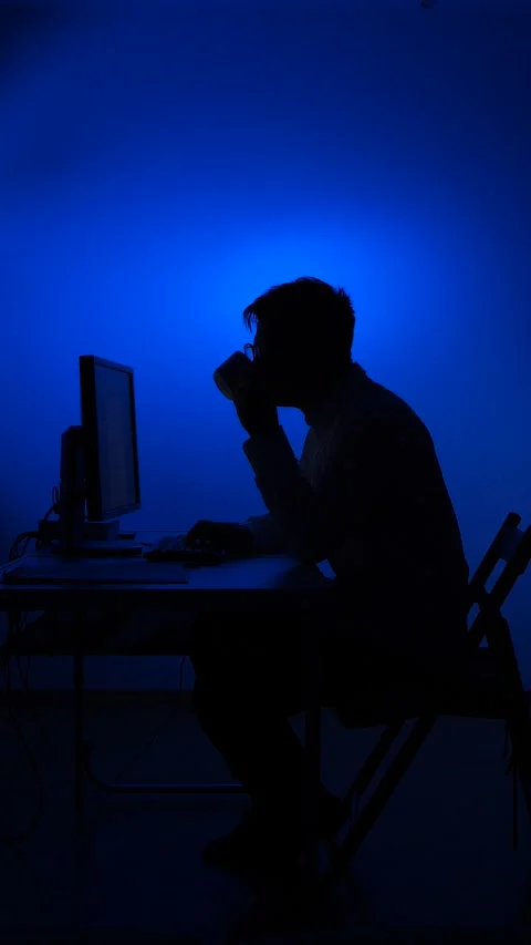 Vertical video Man working late night on computer drinking coffee Stock Footage 318981500