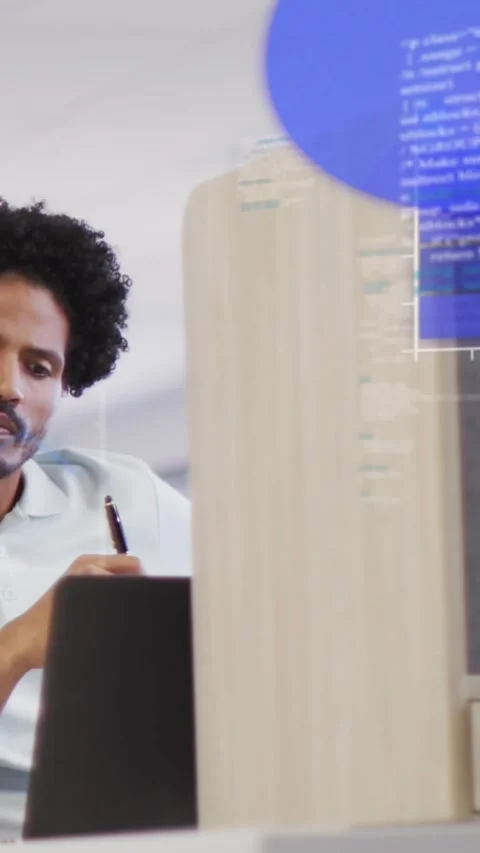 Vertical video: Man writing and tapping phone, causing floating charts and code Stock Footage 334550464