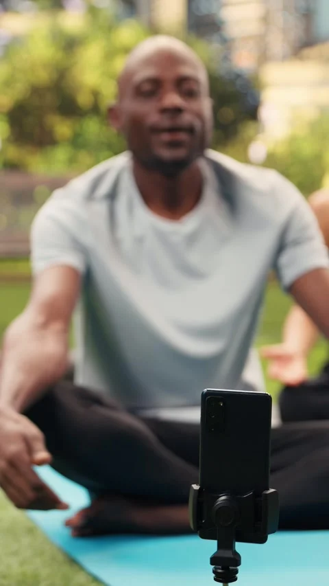 Vertical Video Man yoga instructor recording guided breathing exercise during Stock Footage 346615102