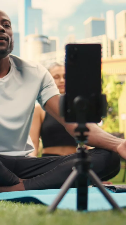 Vertical Video Man yoga instructor recording guided breathing exercise during Stock Footage 346616286