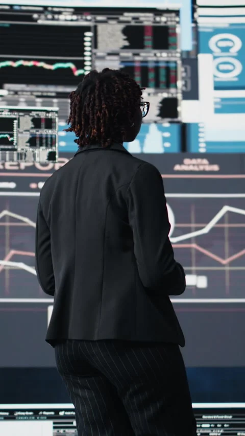 Vertical video Management executive comparing company metrics on digital Stock Footage 318685674