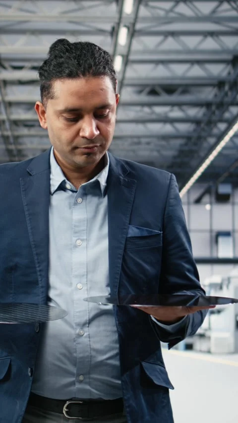 Vertical video Manager examining semiconductor substrates, walking in cleanroom Stock Footage 333614845