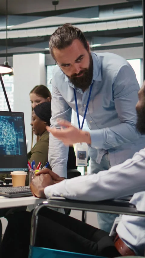 Vertical video Manager supervising developer with paraplegia writing deep Video stock 312708307