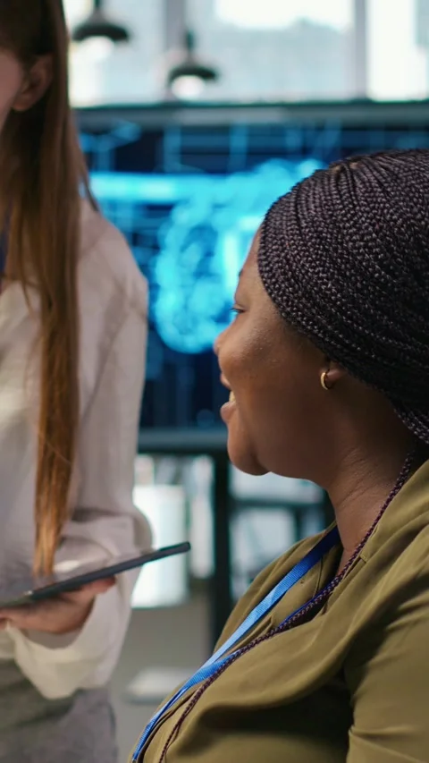 Vertical video Manager teaching young technician how to develop software using Stock Footage 312709401