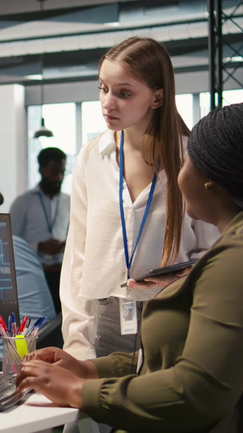 Vertical video Manager teaching young technician how to develop software using Stock Footage 312769534