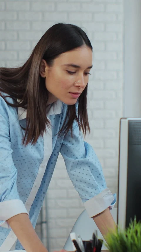 Vertical video. A manager works on a computer in a warehouse. Stock Footage 345726540