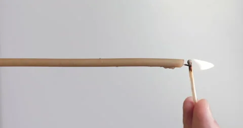 Vertical video. A man's hand lights a single candle with a match Stock Footage 143126024