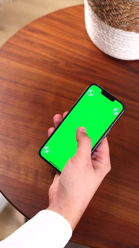 Vertical video with man's hand scrolling smartphone with greenscreen display. Stock Footage 286831710
