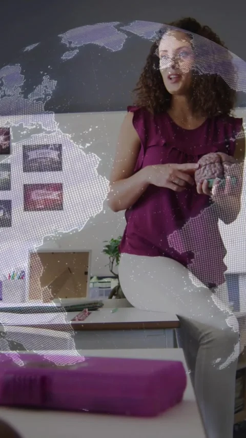Vertical video: Map overlay appearing, teacher holding brain model and pointing Stock Footage 331790334