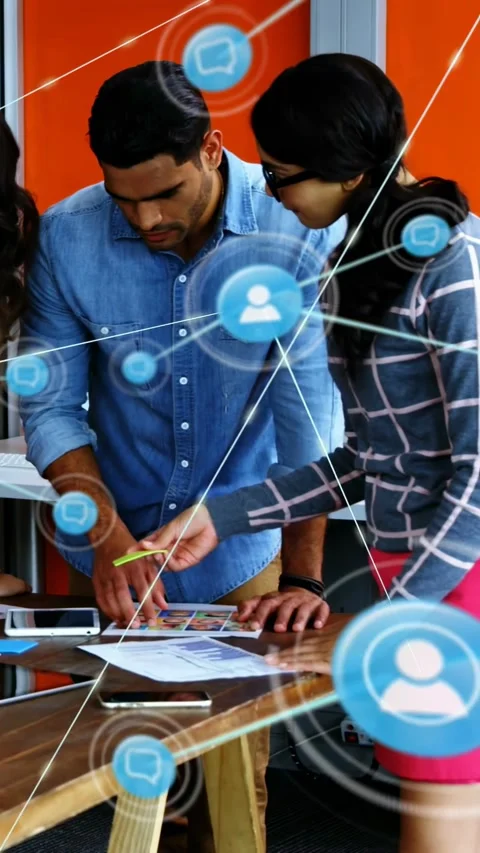 Vertical video: Marketing team organizing layouts for ad taking call network Stock Footage 334046563