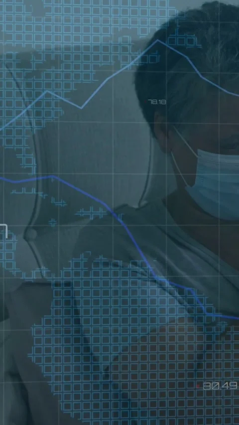 Vertical video: Masked man seated watching tech data overlay appearing with Stock Footage 331178281