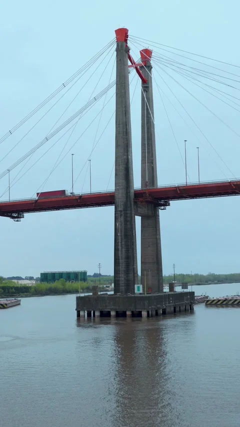 Vertical video of massive concrete pillars and red steel cables Stock Footage 345935860