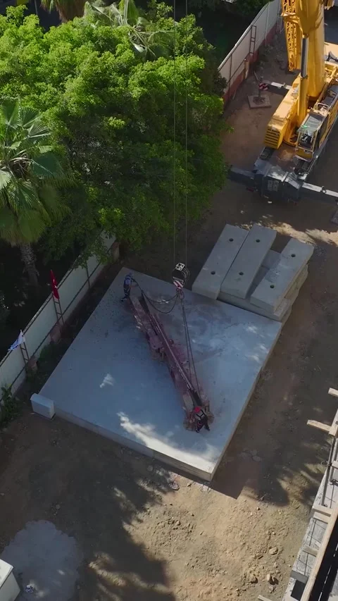 Vertical Video: The massive crane installation progresses smoothly as engineers Stock Footage 297627707