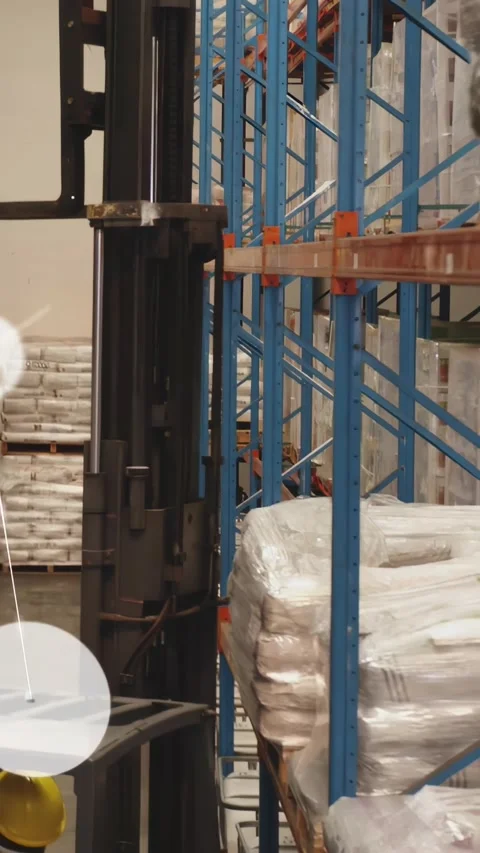 Vertical video: Mast advancing, forklift operator driving aisle, displaying AR Stock Footage 330982298
