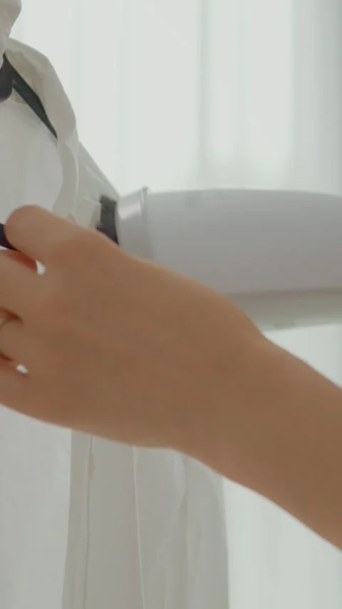 Vertical video Master delicate fabric care by using a steamer for perfect Stock Footage 327598445