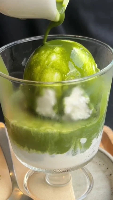 Vertical video of matcha green tea sauce poured on vanilla ice cream Stock-Footage 321182380