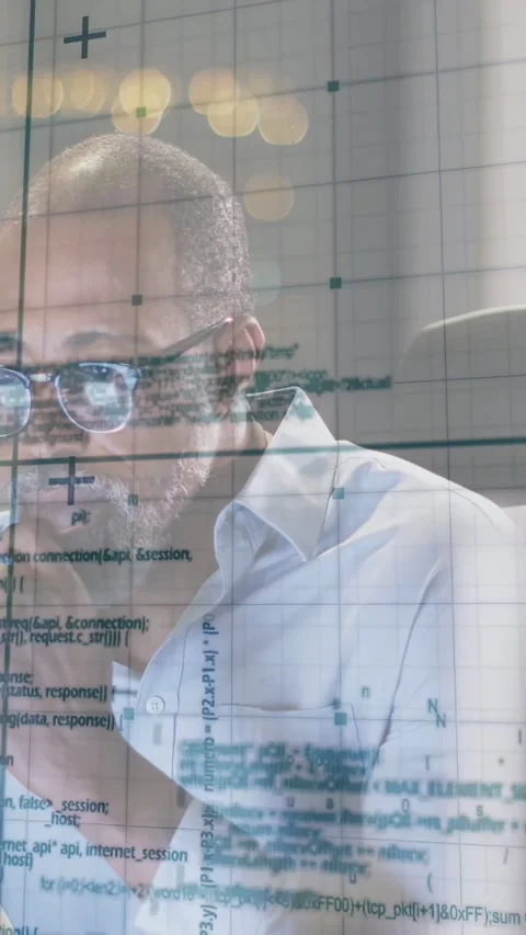 Vertical video: Mature man reading on-screen code, leaning and analyzing with Stock Footage 333109559