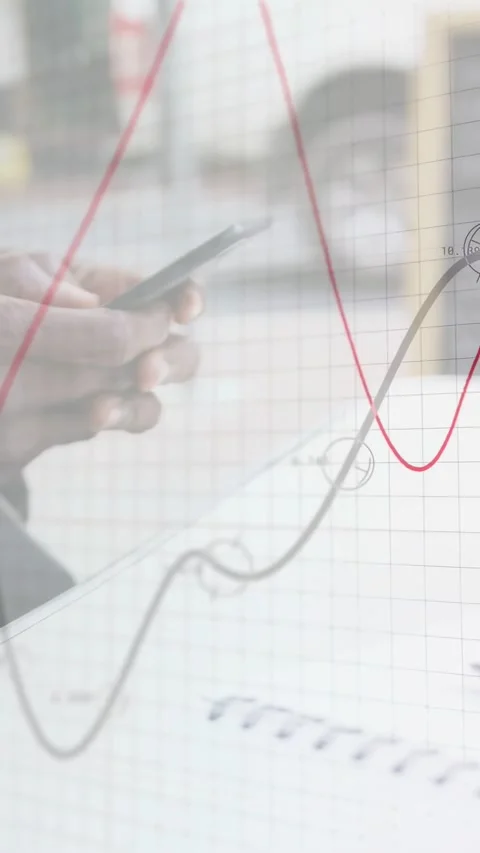 Vertical video: Mature man scrolling phone over notebook shifting inward grid Stock Footage 335263875