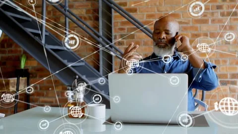 Vertical video: Mature man using phone and gesturing at laptop starting nodes Stock Footage 332289962