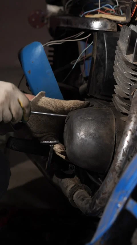 Vertical video mechanic hands wearing work gloves using a tool to carefully Stock Footage 342773947