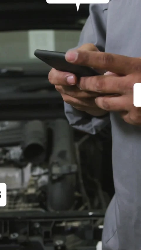 Vertical video: Mechanic seeing alerts tapping phone by engine bay causing icons Stock Footage 331215868