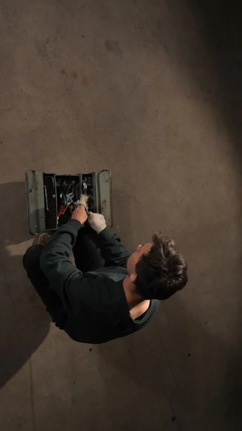 Vertical video mechanic using tools from a metal toolbox, performing repairs Stock Footage 342762373