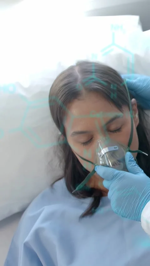 Vertical video: Medic bringing O2 mask, fixing strap on woman in bed for O2 with Stock Footage 333486985