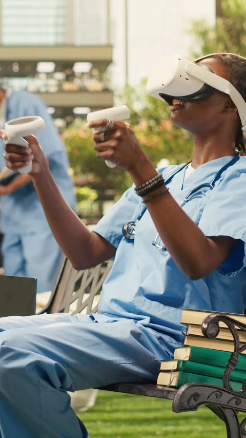 Vertical Video Medical student using VR controllers and headset on wooden bench Stock Footage 341321128