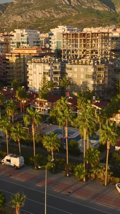 Vertical Video: A Mediterranean villa complex surrounded by palm trees and Stock Footage 297629641