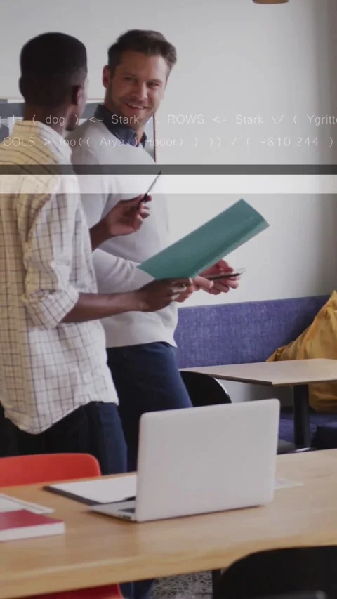Vertical video: Men discussing teal folder handoff for tech while laptop user Stock Footage 334392044