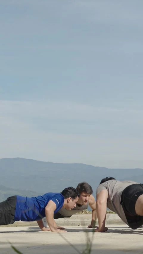 Vertical video of Men Doing Push-Ups Outdoors, Fitness and Teamwork Concept. Stock Footage 282718125