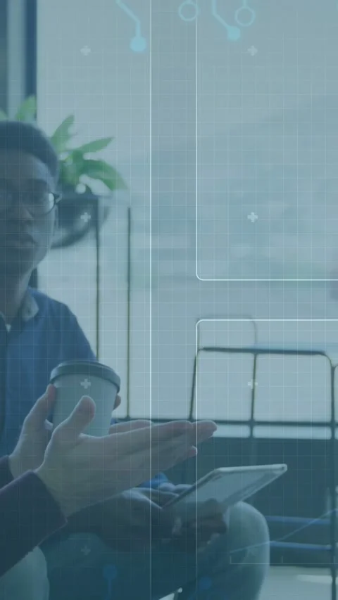 Vertical video: Men holding cup, talking as peer tapping tablet causing tech Stock Footage 333487208