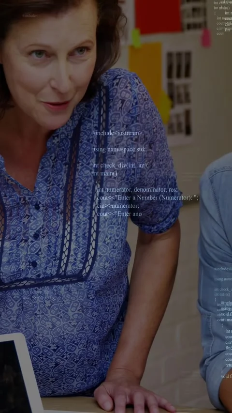 Vertical video: Mentor leaning forward pointing at laptop teaching colleague Stock Footage 332278198