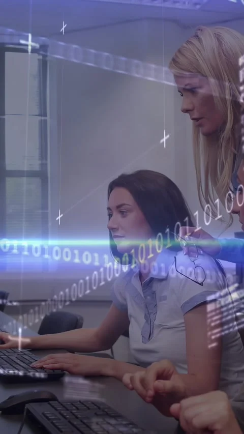 Vertical video: Mentor leaning guiding trainee typing binary overlaying PCs Stock Footage 330982468