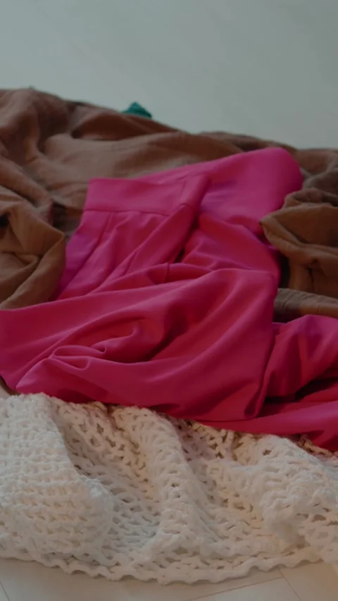 Vertical video Messy clothes scattered on the floor create a chaotic atmosphere Stock Footage 327577267