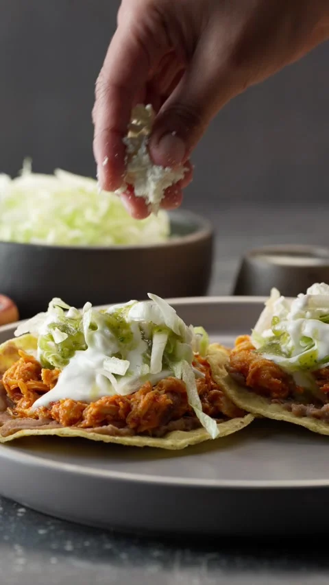 Vertical video, mexican Chicken Tinga Tostadas with lettuce and cheese Stock Footage 282549256