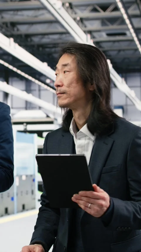 Vertical video Microchip manufacturing plant multiethnic engineering team tracks Stock Footage 333615299