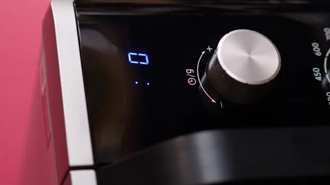 Vertical video. Microwave control panel, screen timer counts down the remaining Stock-Footage 250454887