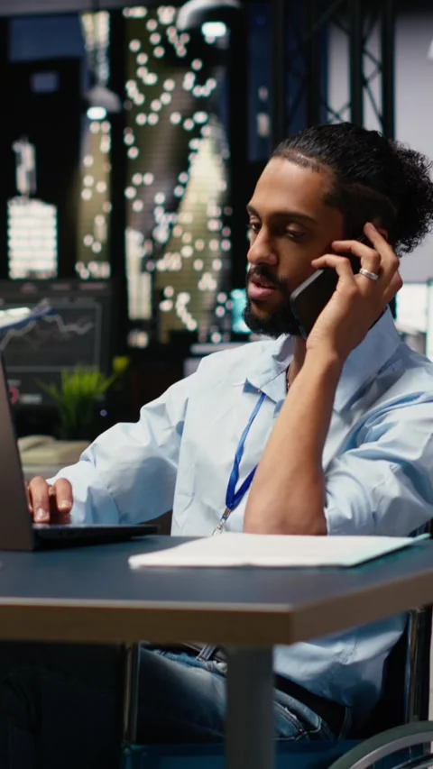 Vertical Video Middle Eastern businessman wheelchair user handling phone call Stock Footage 334105701