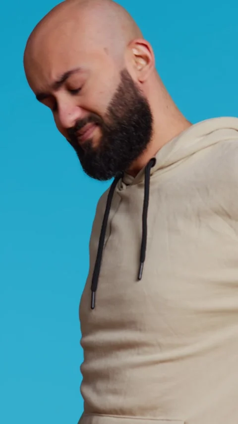 Vertical Video Middle eastern model dealing with lower back pain Stock Footage 263035349