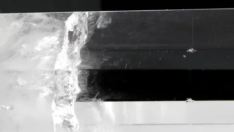 Vertical video. The middle quartz single crystal on a black background. Loop Stock Footage 87467354
