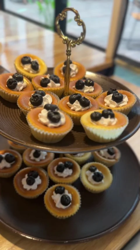 Vertical video of mini blueberry cheesecakes with whipped cream and berries Stock Footage 321182423